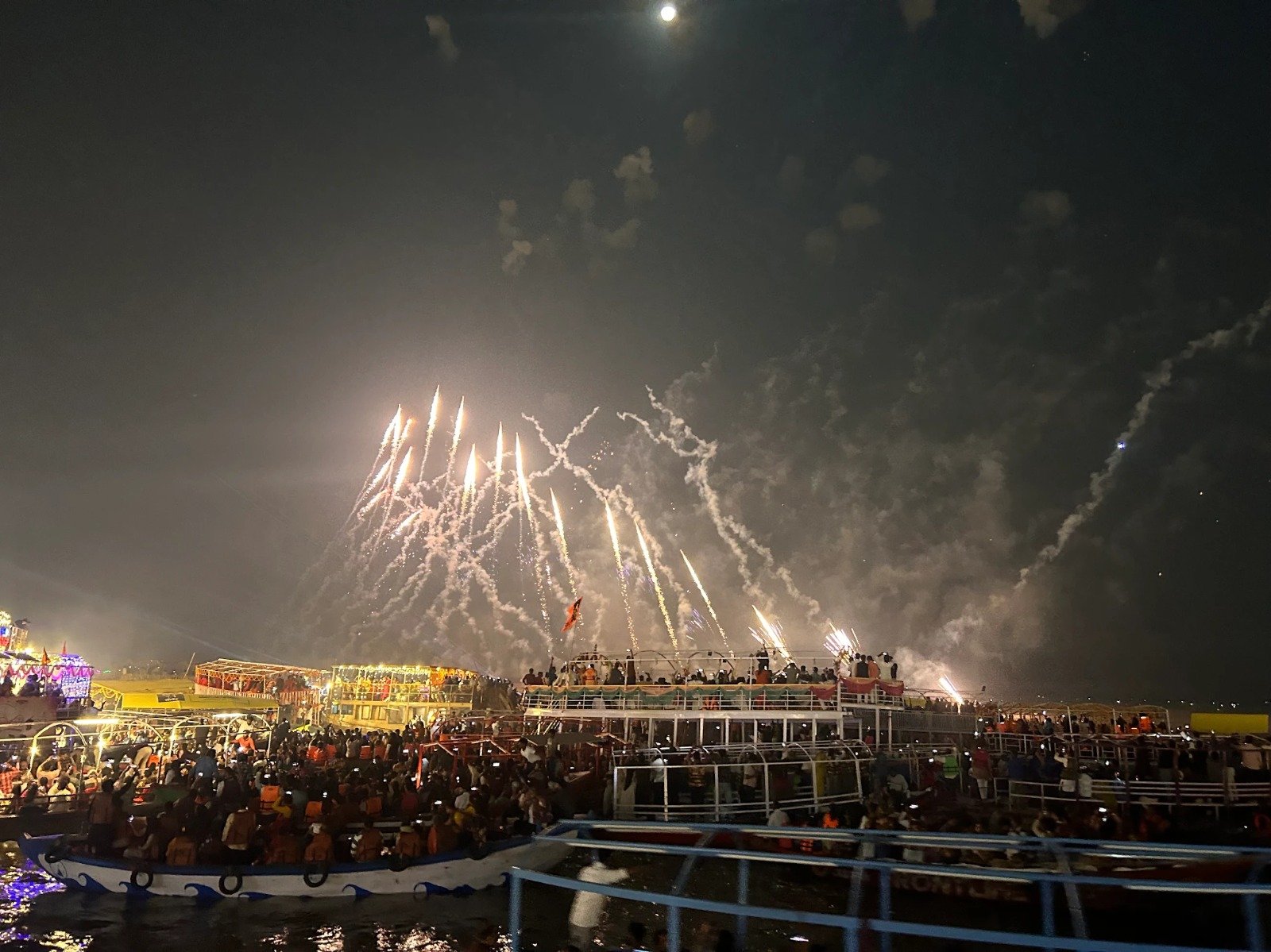 Dev Deepawali diyas lit across the Varanasi ghats, photographed from a Kashi & Kin boat last year