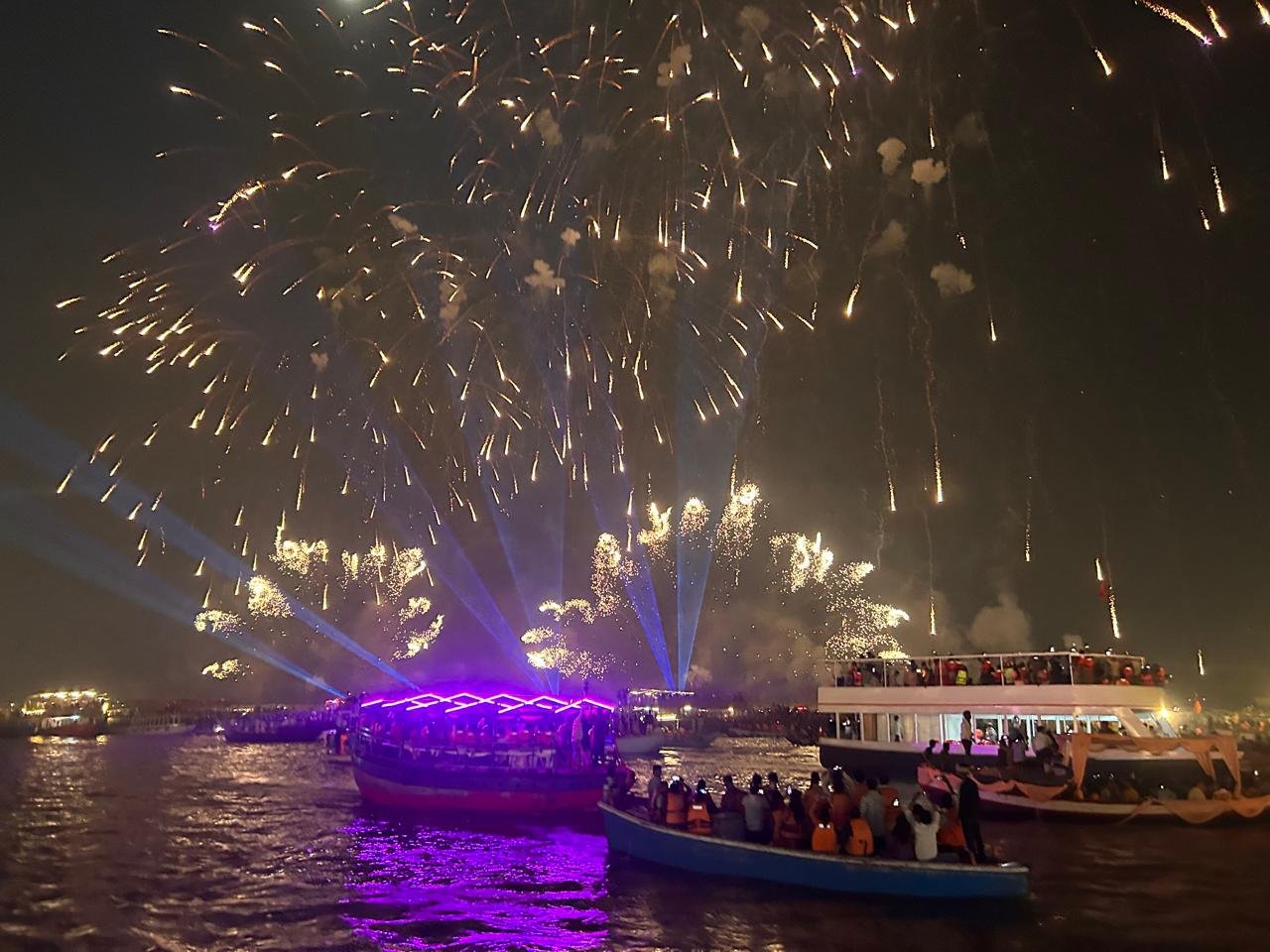 The lit ghats of Varanasi stretching along the river on Dev Deepawali, from a Kashi & Kin boat last year