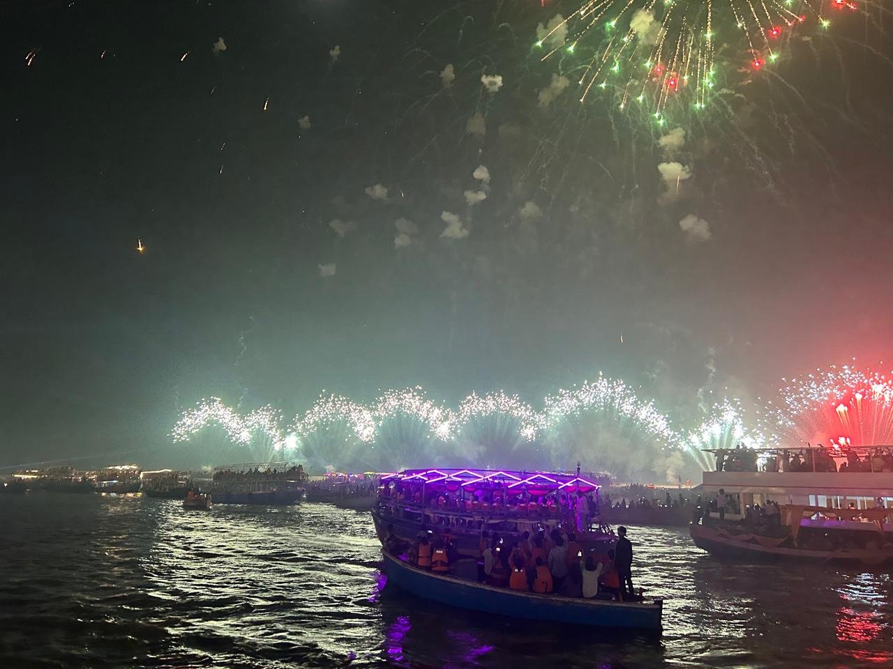 The Varanasi riverfront lit for Dev Deepawali after dark, from a Kashi & Kin boat last year