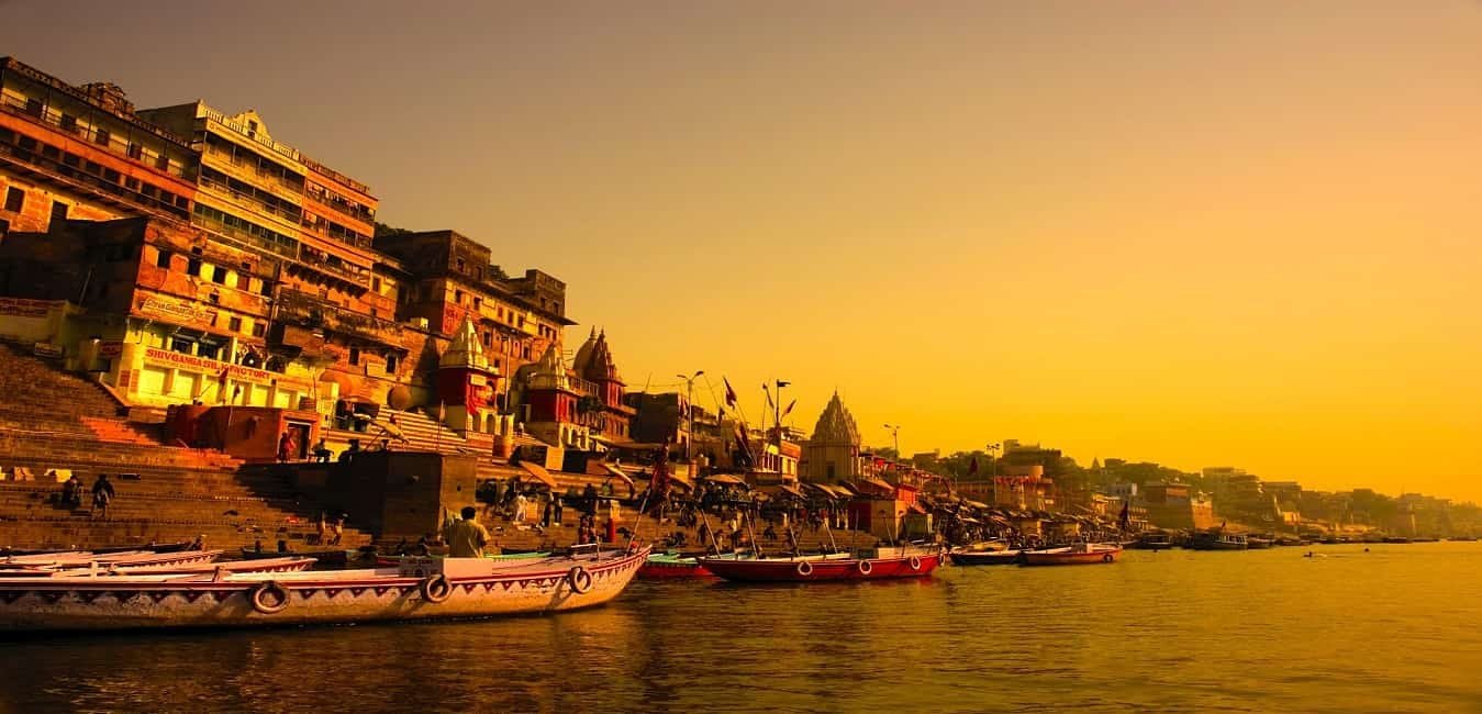 Boats moored along the Ganges at sunset in Varanasi