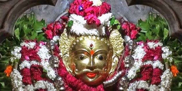 Deity idol adorned with garlands during a pooja ceremony, Varanasi